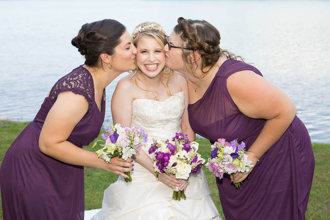 Bridemaids kissing the Bride